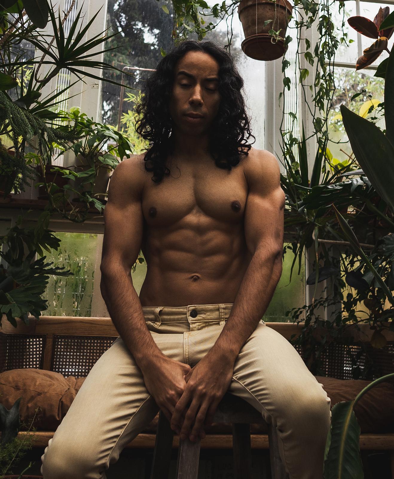Damien framed by botanical textures in a calm portrait setting